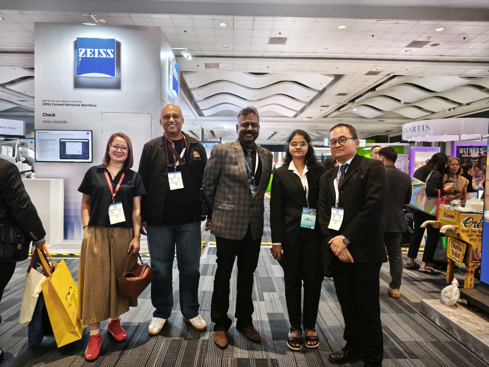 Group of ophthalmology professionals at an exhibition stand